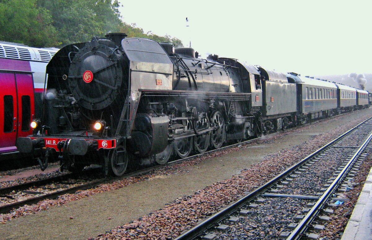 In the pouring rain at Longueville, 141 R-1126 stands with an extra steam train to Paris and Toulouse on 18 September 2011.