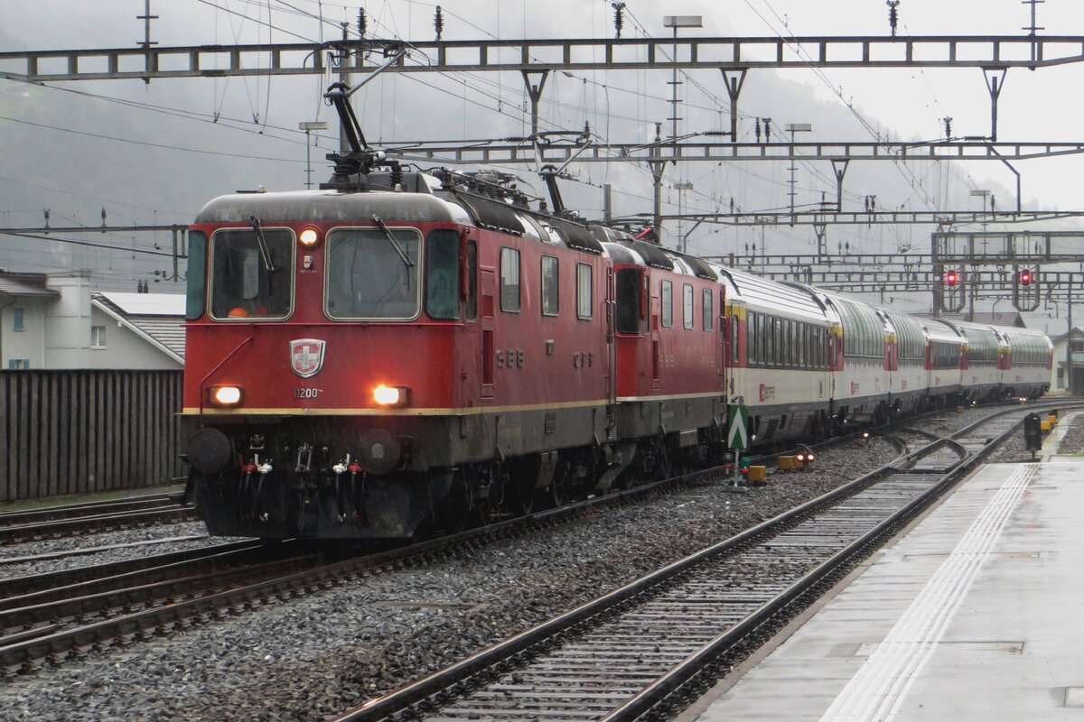 In the pouring rain, SBB 11200 hauls a quasi-retro EuroCity into Erstfeld on 19 September 2021.