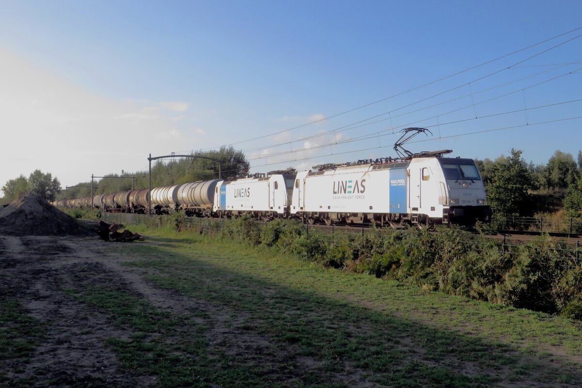 Lineas 186 294 hauls a tank train through Tilburg-Reeshof as the Sun is about to set on 15 October 2021.