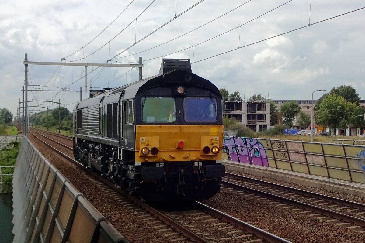 MRCE 653-01 speeds throguh Tilburg-Reeshof station on 16 August 2019.