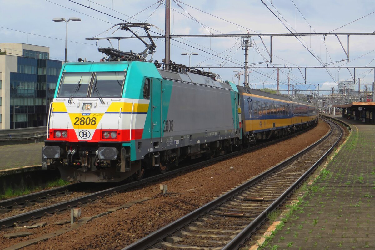 NMBS 2808 suffered a serious accident in 2021 but despite the heavy damage was completely restored, earning the name De fenix (The Phoenix) due to her resurrection. The Fire Bird stands with an IC-Brussel in Antwerpen-Berchem on a wet and grey 5 May 2023.
