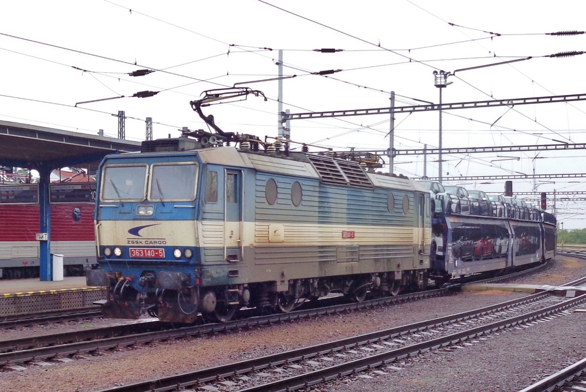 On a rainy 19 September 2017, ZSSK 363 140 hauls an automotive train through Bratislava hl.st. 