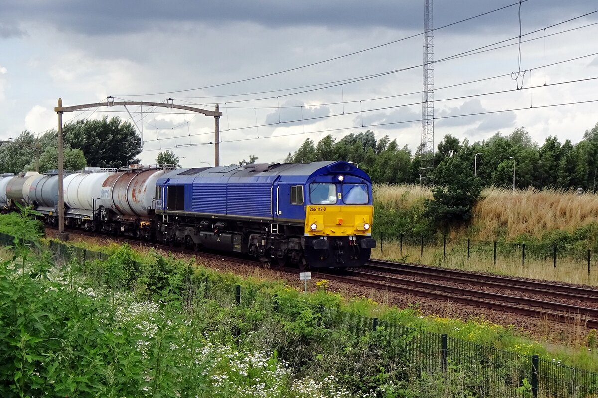 RailTraxx 266 113 hauls a tank train through Tilburg Reeshof on 7 July 2021.