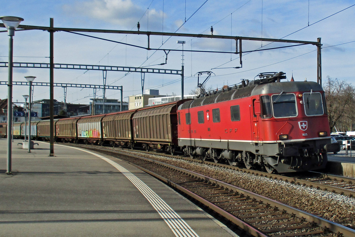 SBB 11628 speeds through Thun with a mixed freight on 23 March 2017.