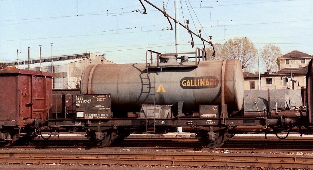 Tank Wagon FS Gallinari - used for hauling wine and fruit juice - in Milano, March 1984. You can see 2 other similar tank wagons here http://www.drehscheibe-online.de/foren/read.php?17,6297846 
