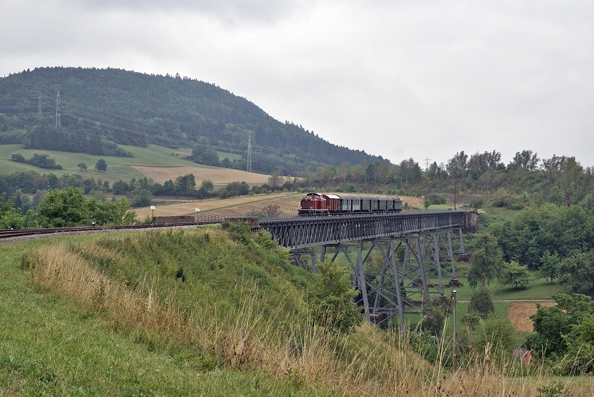 The diesel locomotive 211 041-9 (92 80 1211 041-9 D-NeSA) drives its  morning train  over the  Talübergang Epfenhofen Bridge , which is the longest bridge on the Sauschwänzlebahn at 264 meters long. August 27, 2022