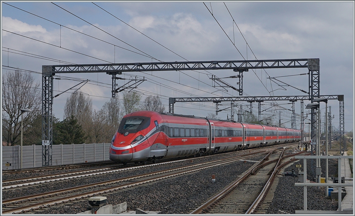 The FS Trenitalia ETR 400 052 lives up to its name and travels incredibly quickly through the Reggio Emilia AV train station heading south. 

March 14, 2023