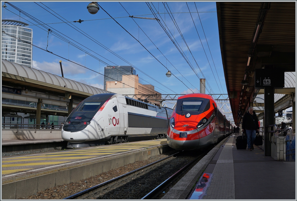 The FS Trenitalia Freccia Rossa ETR 400 031 is traveling as FR 6647 from Paris Gare de Lyon to Lyon Perrache. The picture shows the elegant train making its only stopover at Lyon Part Dieu station. The inOui TGV Duplex rame 264 can be seen on the left in the picture. 

March 13, 2024