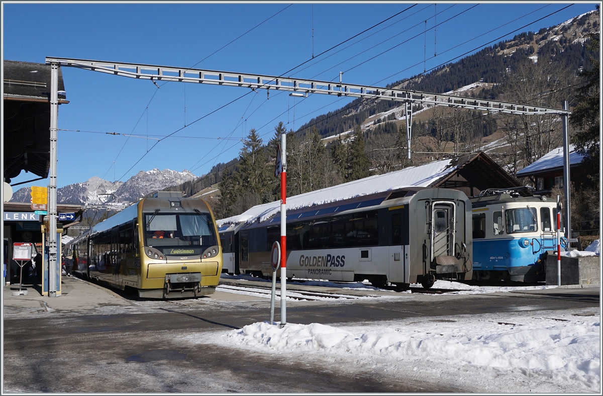 The MOB ABt 344 - Be 4/4 5004 - Bt 244 (->  Lenkerpendel ) in Lenk im Simmental.
In the background MOB Panoramic wagons and the ABDe 8/8 4004  Fribourg 
 25.01.2022