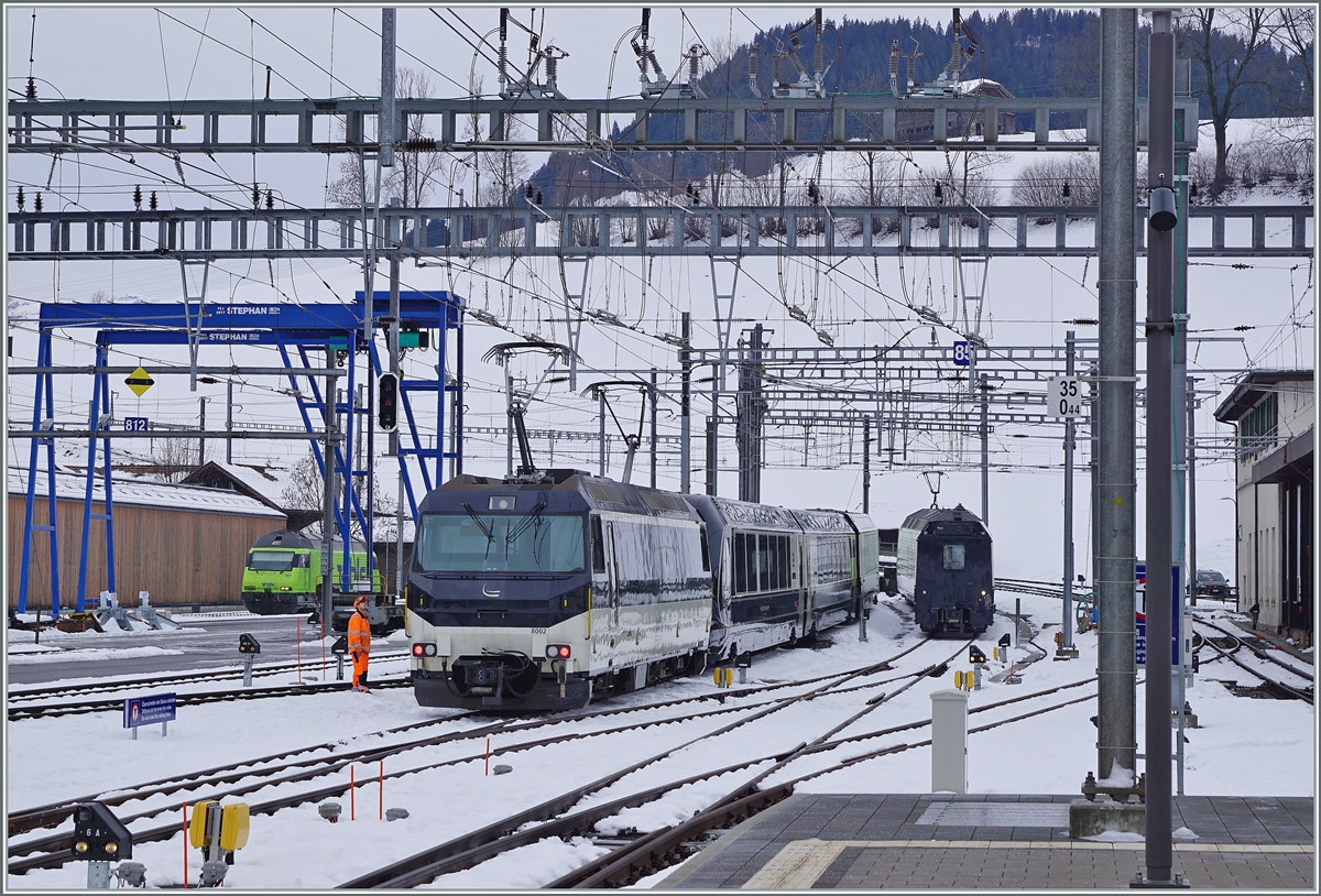 The MOB Ge 4/4 8002 is leaving with his GoldenPass Express GPX 4065 from Interlaken Ost to Montreux from the Station of Zweisimmen.

In the background is waiting the BLS Re 465 007.

15.12.2022