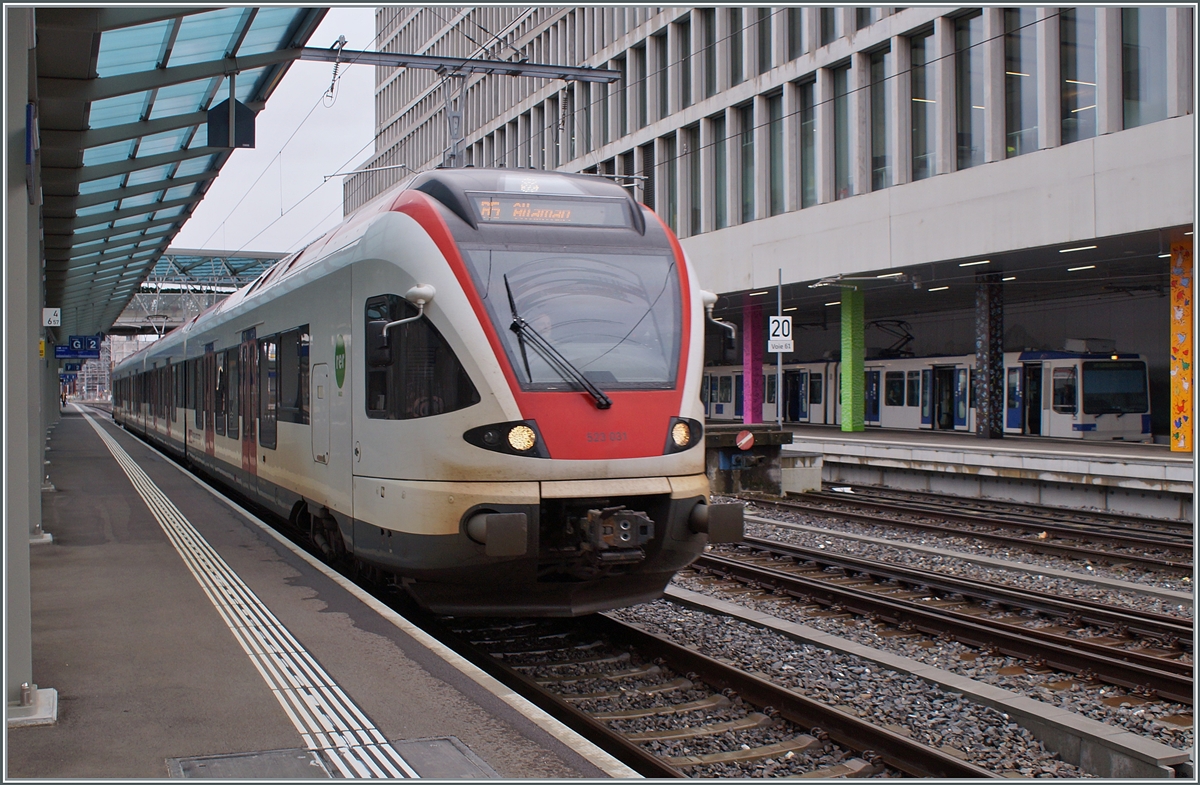 The SBB RABe 523 031 on the way to Allamn by his stop in Renens VD. In the background a TL TSOL Be 4/6 (Be 558). 

14.12.2023