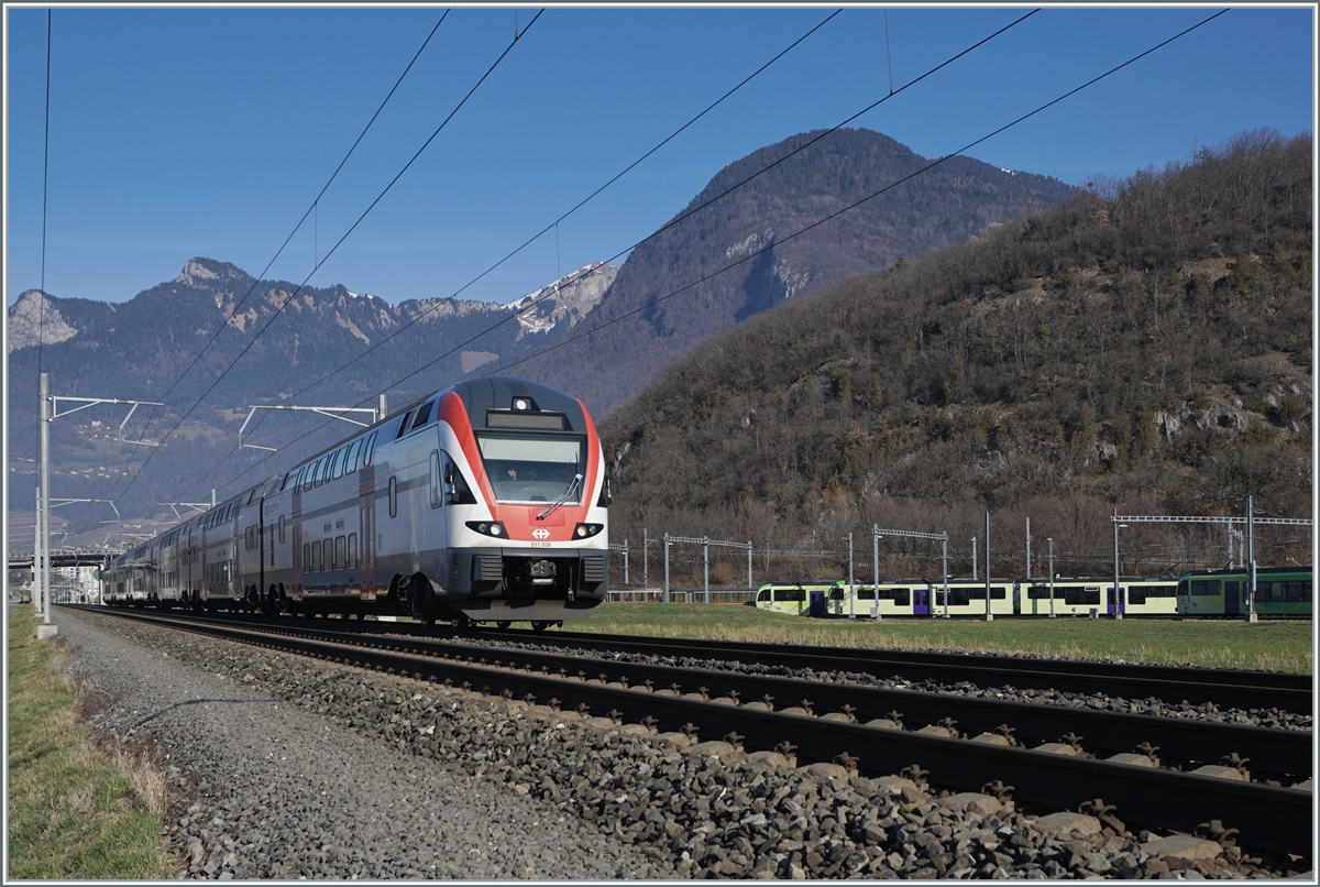 The SBB Stadler KISS RABe 511 038 is shortly after Aigle as RE 33 on the way to St-Maurice. On the right in the picture is the TPC Dépôt En Châlet with various TPC vehicles.

Feb 4, 2024