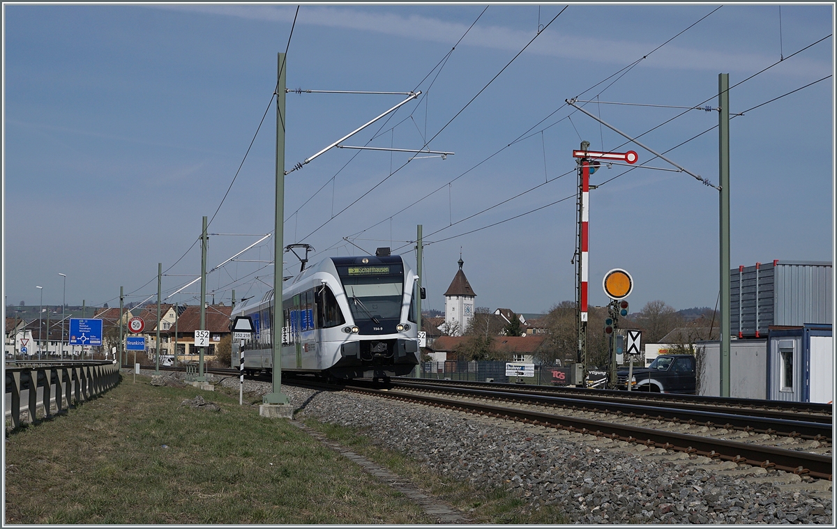 The SBB THURBO RABe 526 734-9  bwegt  on the way to Schaffhausen by Neunkirch (CH). 25.03.2021