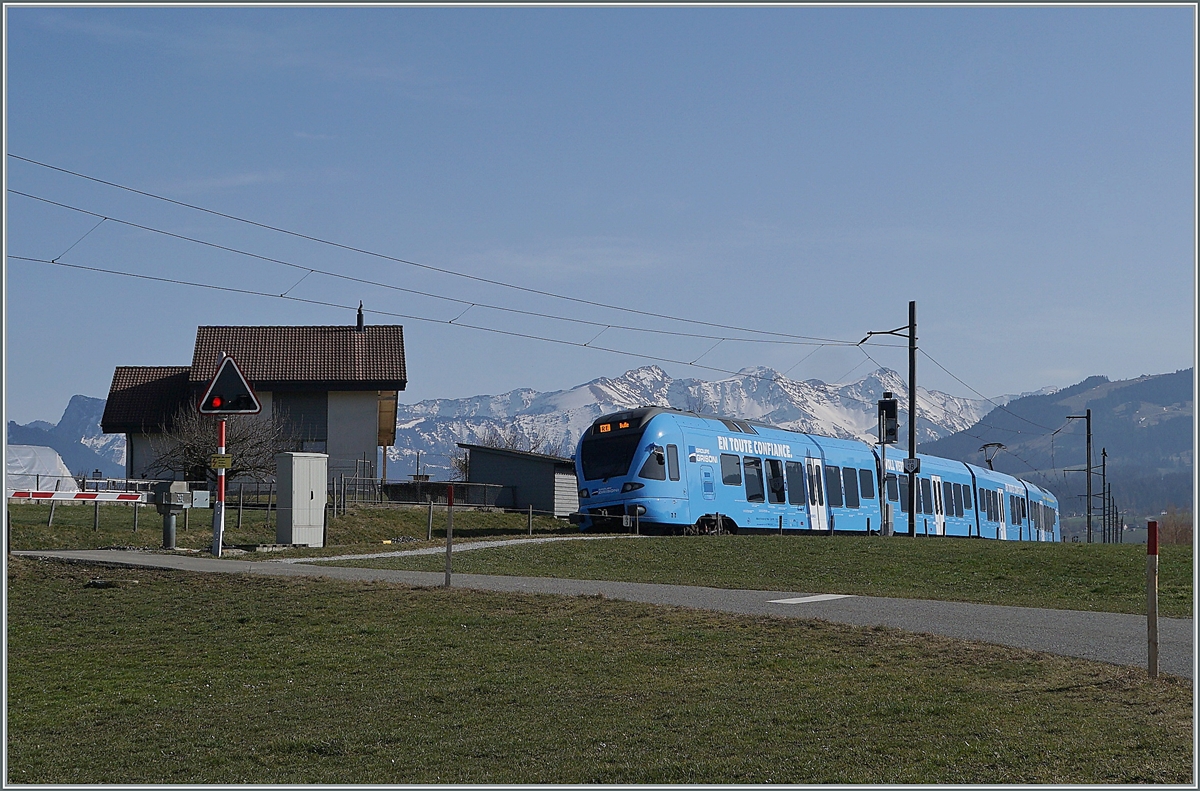 The TPF  Groupe Grisoni  TPF RABe 527 198 on the way to Bulle near Vaulruz.

02.03.2021