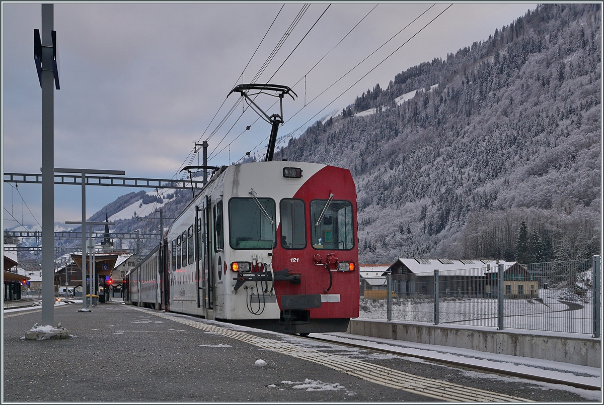 The TPF local train with the Be 4/4 121, B 207, B209 and ABt 221 is waiting in Montbovon to is departure to Bulle. 

03.12.2020