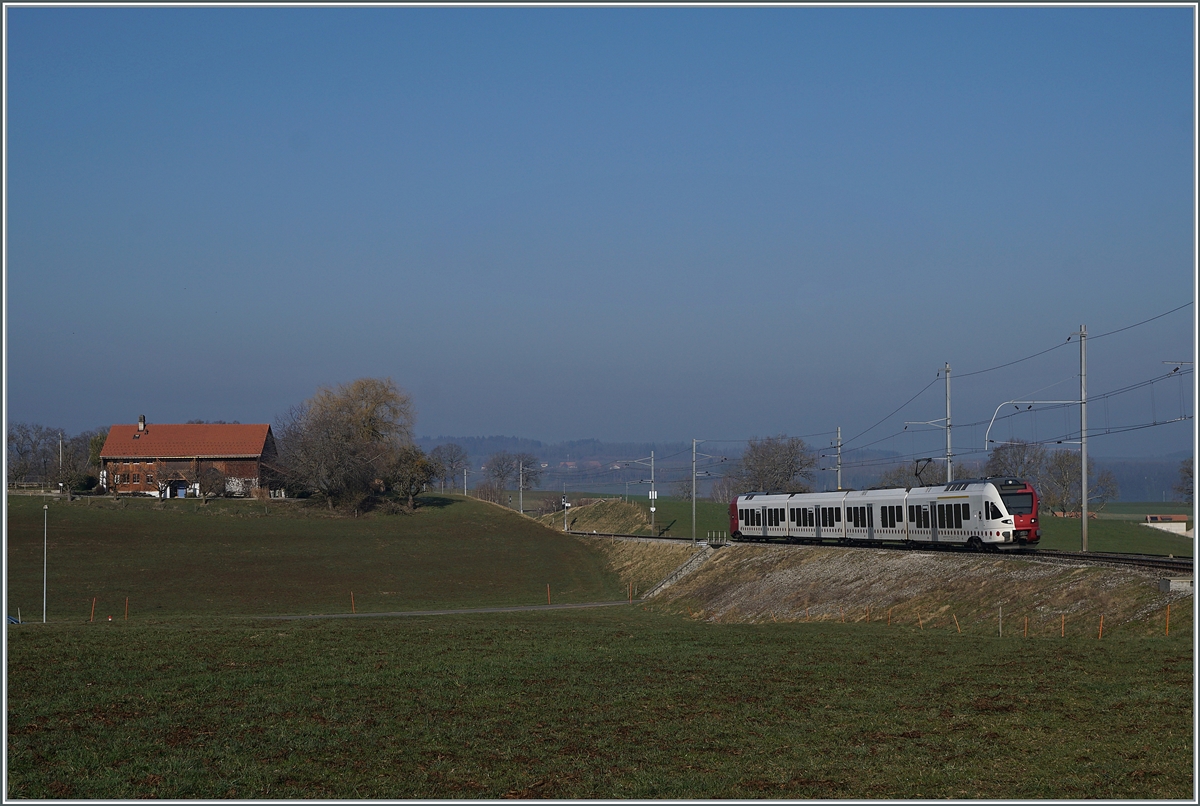 The TPF RABe 527 191 on the way to Fribourg by Vuisternens-devant- Romont. 

1. März 2021