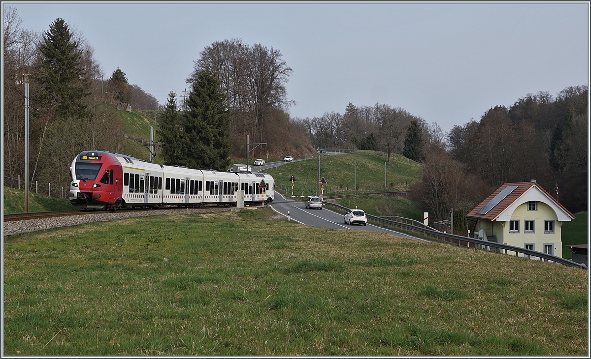 The TPF RABe 527 197 on the way to Fribourg by Pensier. 

29.03.2022