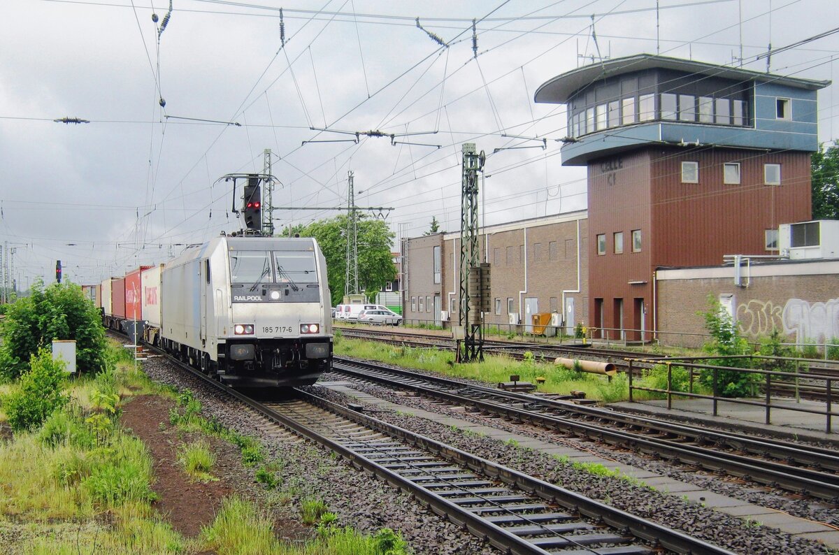 Under the watchful eyes of the control tower Railpool 185 717 hauls a container train through Celle on 1 June 2012.