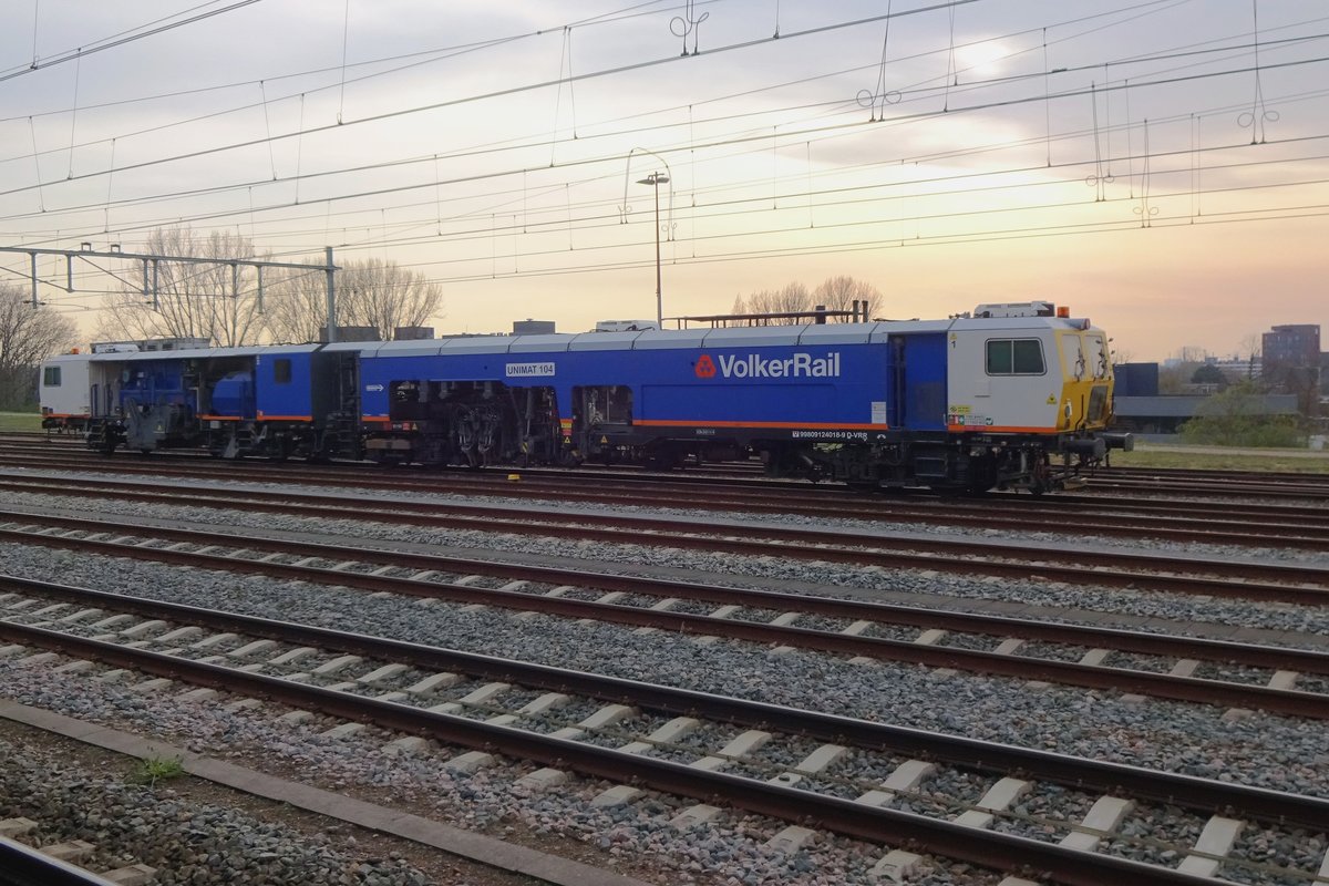 Volker Rail UniMat 104 stands stabled at Nijmegen on 8 April 2021 and is greeted by the setting twilight.