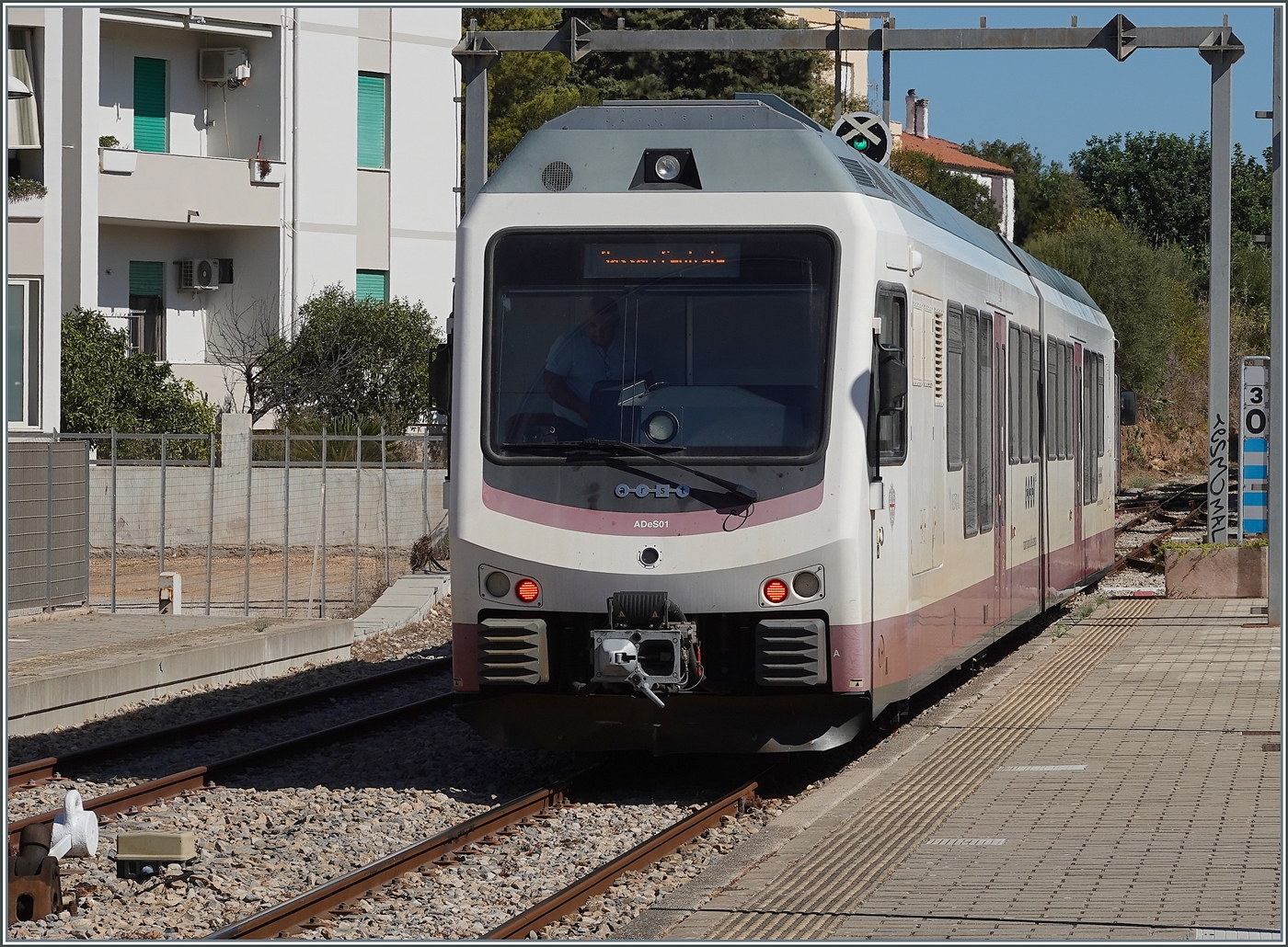 The ARST (regional transport of Sardinia) ADeS01 (95 83 4600 001-0 [A] / 95 83 4600 101-8 [B]) double railcar departs Alghero as AT 70 to Sàssari.

September 22, 2026