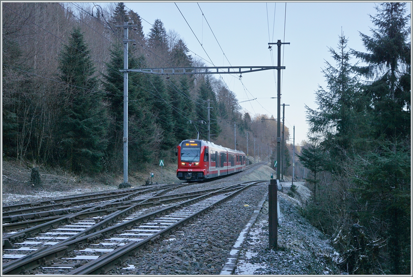 The CJ ABe 4/12 672 reaches Combe Tabeillon station. This station is located in the middle of the forest. Here, the trains on the La Chaux-de-Fonds - Glovelier route change direction. Such switchback stations also exist in the Jura at Morez (F) and Chambrelien (canton NE).

January 13, 2025