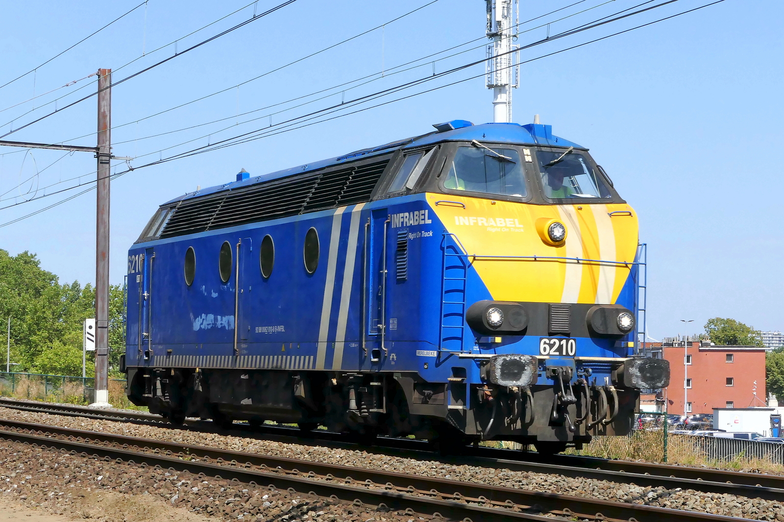 The Infrabel 6210 coming from the port of Antwerp. BN Brugge HLD 62 build in 1962 with construction N� 212 110.  NMBS Class 62: between 1961 and 1966 136 of these diesel locomotives were build by BN Brugge. Numbers: 6201 to 6333 and 6391 to 6393. Max speed: 120km/h. Power: 1030kW. 48 are still in service at Infrabel. Line 27A at Antwerp Airport. 04-08-2026