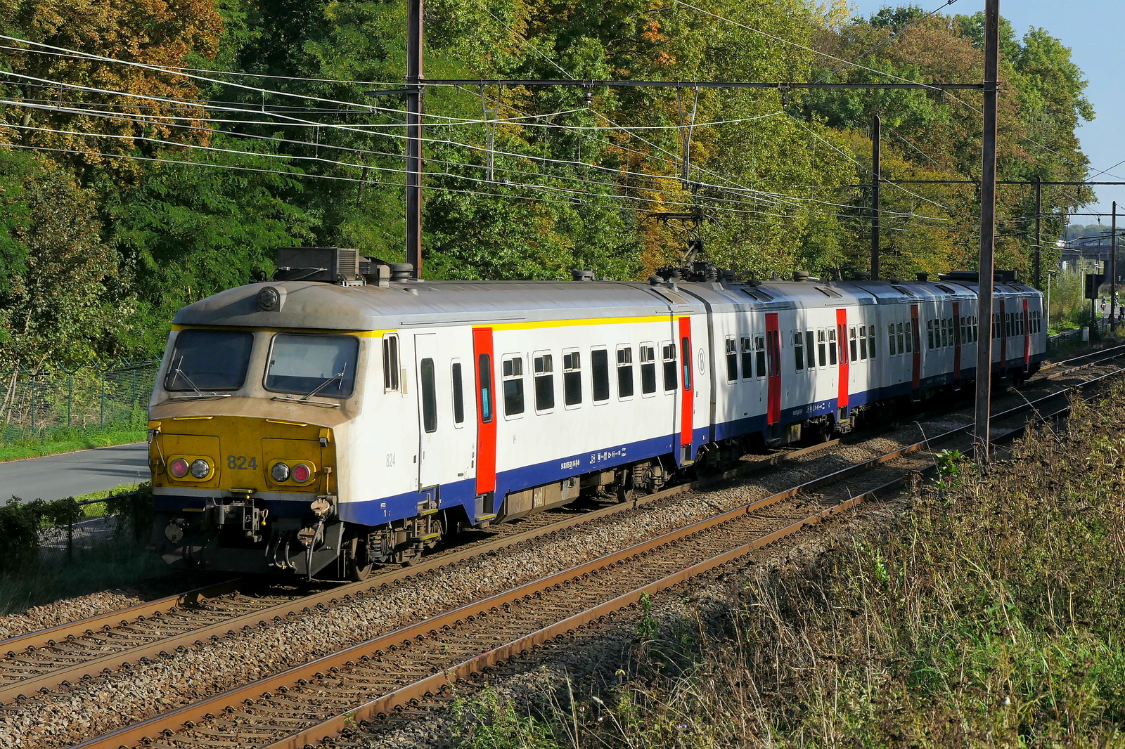 The NMBS 824 on route from Antwerpen-Berchem to Lier station. BN Brugge MS75 build in 1976, modernized in 2017 and 2024. NMBS Class MS75 (MR75/EMU75) : Between 1975 and 1977 44 of these EMU (Electric Multi Unit) were build by BN Brugge. Numbers 801 to 844. Number of Carriages: 4. Length: 99,03m. Number os seats: 368. Max speed: 140km/h. Power supply: 3000V and 1500V (NL). Modernized between 2015 and 2020. Nickname: Pig Nose. Line 27A at Antwerp Airport. 06-10-2026