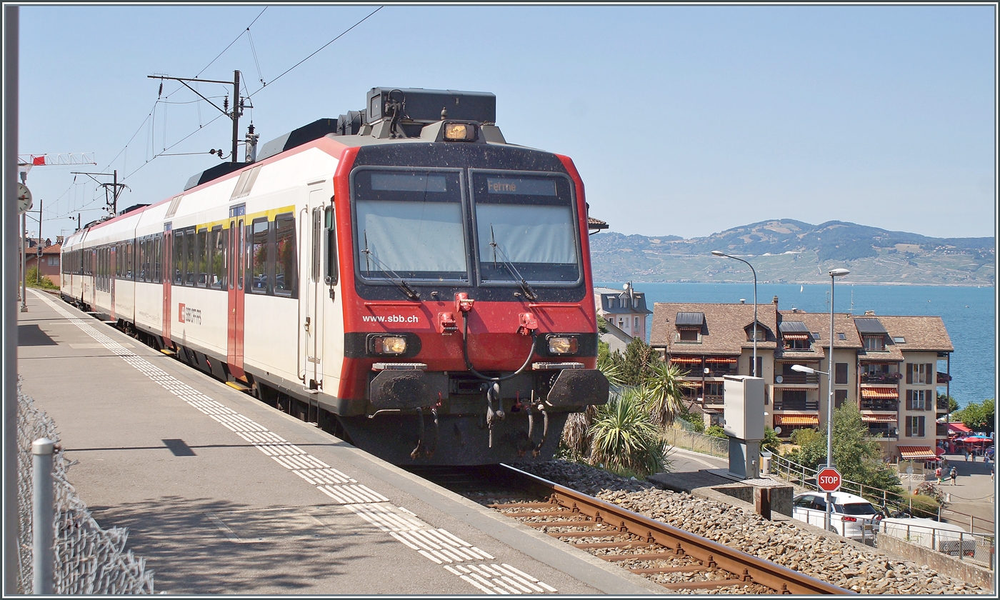 The Region Alpes regional train R91 6125 is waiting in Saint Gingolph for departure (15:51) to Brig (arrival 17:56). In service for this route is an SBB Domino with the ABt NPZ Do 50 85 39-43 814-5 CH-SBB at the front, the B NPZ Do 50 85 29-43 150-6 CH-SBB as an intermediate car, and the pushing RABe 560 217 (UIC RABe 560 DO 94 85 7 560 217-2 CH-SBB) at the rear of the train.

July 22, 2026