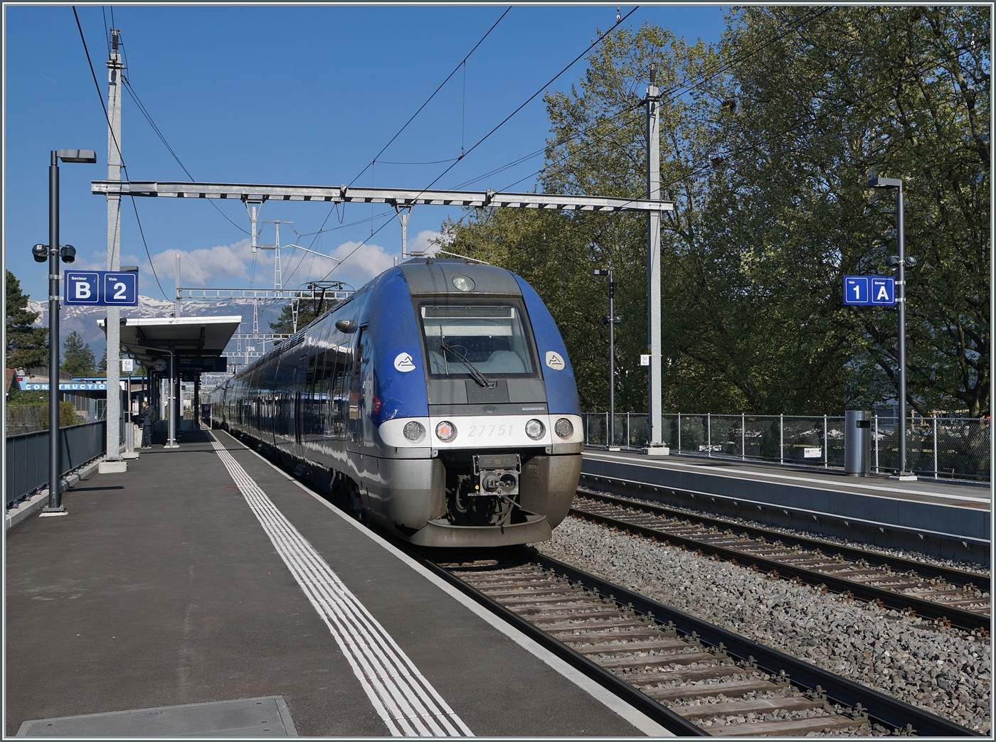 With the final multiple unit train 27751, three SNCF Z27500 (AGC - ZGC) are on their way from Genève to Lyon in Satigny.  
Of course, the train passes through Satigny without stopping.  

April 16, 2026