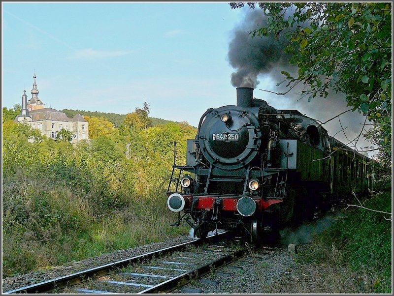 . The steam train is passing near the solemn castle at Vierves-sur-Viroin on its way from Treignes to Mariembourg. Vierves-sur-Viroin is catalogued as one of the most beautiful towns of Wallonie. The town is built around  the castle, which preserved its appearance of the XVII century due to the recontruction after a fire. September 27th, 2009.