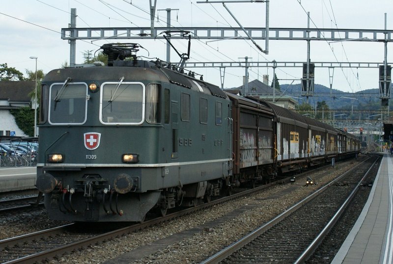 In the last evening light is coming one of the last Re 474 II in green: 
SBB Re 4/4 II 11309 with a Cargo Train in Liestal
02.10.2009