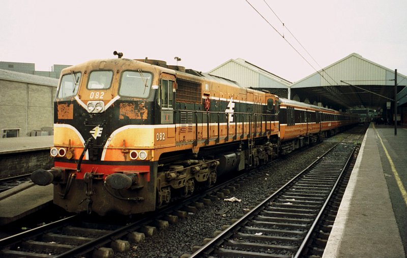 The CIE (Iarnród Éireann) diesel locomotive CC 082 is waiting in Dublin Connolly Station (Baile Átha Cliaht Stáisún Ui Chonghaile) with its IC to depart for Sligo. 

Analog image from June 2001