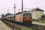 Coal train, headed by 1044 098, speeds through Bruck (Leitha) on 25 May 2002.