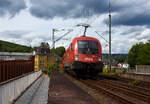 The Taurus II, �BB 1116 049 (91 81 1116 049-8 A-�BB) of �BB-Produktion GmbH, is running on June 11, 2026, with an automobile transport train of the Rail Cargo Group (double-deck automobile transport wagon of the Laaers class (560.2) loaded with cars from the Ingolstadt brand with four rings), through Kirchen/Sieg towards Cologne. On the left in the picture is the former Arnold Jung locomotive factory where over 12,000 locomotives were built, including the last steam locomotive of the Deutsche Bundesbahn, the 23 105.