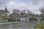 Two AVA BDWM ABe 4/8 'Diamant' trains in different liveries are traveling from Dietikon to Wohlen shortly after the Bremgarten Obertor stop (which is not served during the Christmas market), crossing the photogenic 156-meter-long Reuss Bridge. Decemb ...