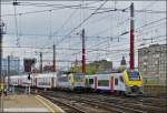. The AM 08 006 is entering into the station Bruxelles Midi, while the HLE 1846 is leaving it on May 10th, 2013.