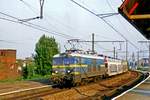 NMBS 2513 hauls a train with cars through Anmtwerpen-Dam on 15 May 2002.