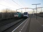 NMBS 2813/186-205 storms through Zwijndrecht with an Express for Brussels while a SLT 6-car set leaves as local train for Breda, 02/01/2015.