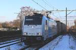 The Sun begins to disappear when on 19 January 2024 Lineas 186 456 hauling the Volvo container train towards Antwerpen passes through Gilze Rijen and gets photographed from the station's  platform.