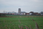 L-train Zeebrugge-Brugge passing Lissewege church in January 2014.