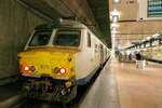  The NMBS 815 at platform 14, level -1 at Antwerpen Centraal. NMBS Class MS75 (MR75/EMU75) : A total of 44 of these EMU (Electric Multi Unit) were build between 1975 and 1977 by BN Brugge. Numbers 801 to 844. Number of Carriages: 4. Length: 99,03m. Number os seats: 368. Max speed: 140km/h. Power supply: 3000V and 1500V (NL). Modernized between 2015 and 2020. Nickname: Pig Nose. Antwerpen Centraal. 24-10-2026