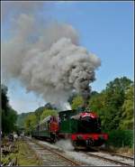 The steam engines  Helena  and Tkh 5887 are leaving the station of Dorinne-Durnal on August 14th, 2010.