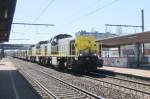 SNCB leads two sisters (a so-called triplette in Belgium)and a train of empty auto-transporters through Antwerpen-Noorderdokken on 20 April 2013.