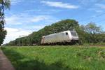 Akiem 186 359 hauls an empty container train through Tilburg Oude Warande on 19 July 2020.
