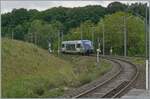 450 kilometers from Paris, the SNCF Coradia A-TER X 73755  Baleine  as TER 8950011 from Belfort to Delle leaves Meroux station. Photographically almost perfect, the length of the train fits exactly between the kilometer marker and the catenary mast.

May 20, 2026