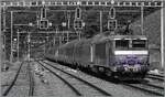 A colorful black-and-white image: The SNCF BB 22391 'Nez cassé' is running with its TER 96634 through La Plaine station and will soon reach France. The old DC catenary masts, retrofitted with SBB overhead line equipment, are still standing and n ...
