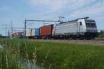Akiem/RFO 186 003 (formerly with NS Reizigers in yellow and blue) hauls a container train through Valburg on 30 May 2026.