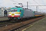 NMBS 2808 suffered a serious accident in 2021 but despite the heavy damage was completely restored, earning the name De fenix (The Phoenix) due to her resurrection. The Fire Bird stands with an IC-Brussel in Antwerpen-Berchem on a wet and grey 5 May 2023