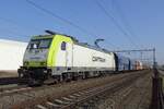 CapTrain 186 158 passes Blerick with a colourfull empty coal train toward Rotterdam on 5 March 2022.