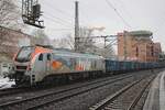 HVLE 159 007 hauls a train of empties through Hamburg-Harburg on a grey 13 February 2026.